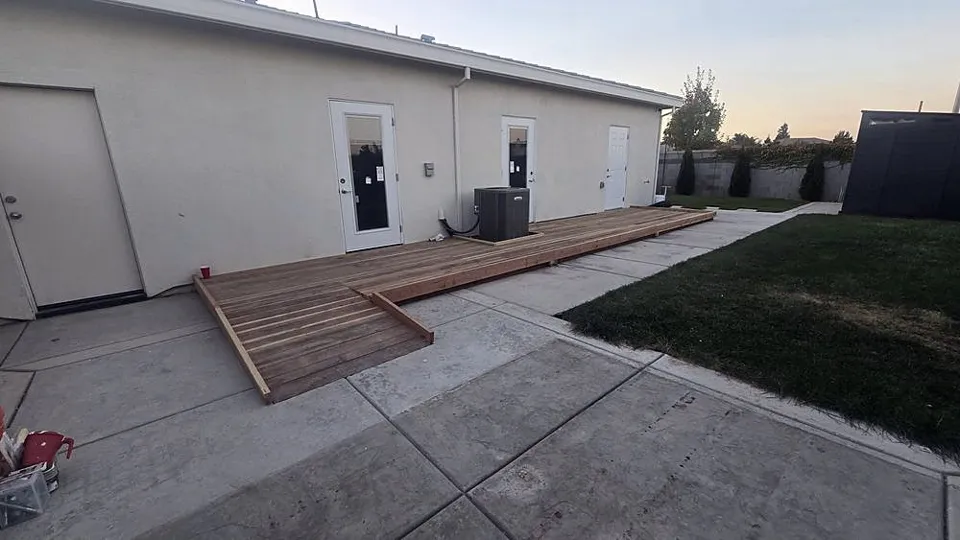 Wood accessibility ramp along the back of a house