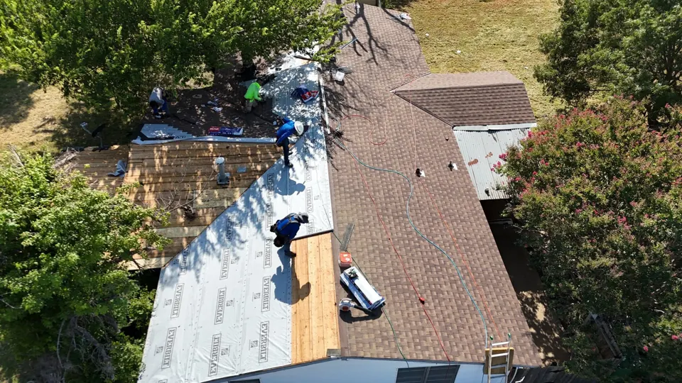 Crew installing new shingles